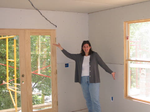 A Happy Bethany showing off the Drywall in the Great Room